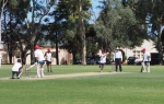 Alan Davidson wheeling away at the Margaret Street end of Glandore Oval. Paul 'Panda' Angley in charge as ump